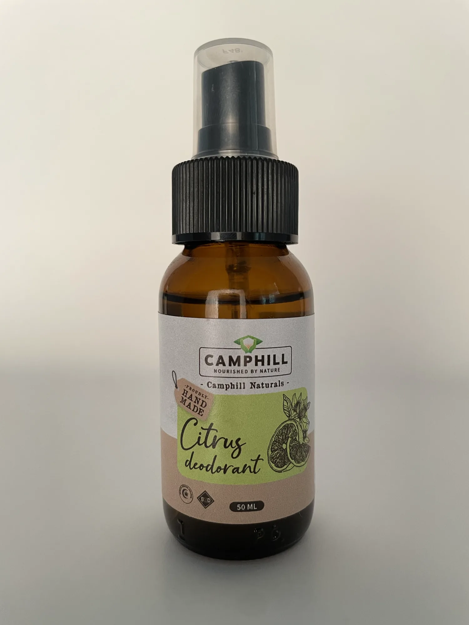 A 50ml amber glass spray bottle of Camphill Citrus Deodorant, labelled Camphill Naturals and proudly hand made