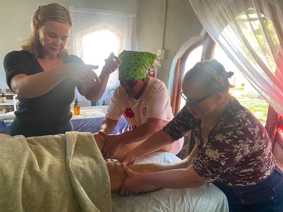 Betti Lou and Jennien practising a massage technique during their training session
